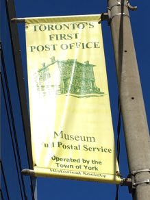 Toronto's First Post Office and Museum flag outside building on Adelaide Street East