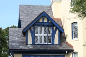 Mottled Purple and Green slate roof installed with 18" length slates by random widths providing architectural detail