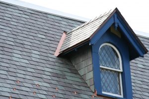 Dormer window with slate wall cladding, copper open valley, wall underrlayment, apron flashing, slate shingles