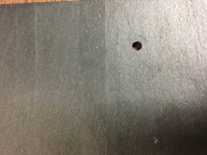 Image of nail hole punched from the back of the slate